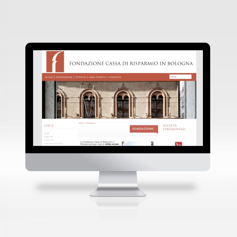 Fondazione Cassa di Risparmio in Bologna website on a monitor: red header and the historic façade of its headquarters